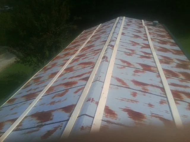 Rusted metal roof panels with new wood purlins before replacement — Storm Damage Roof Repair in Mc Clellanville by Roofing Brothers